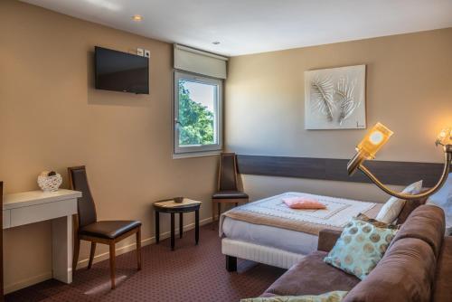 Foto de una habitación de Hotel Les Orchidées Logis