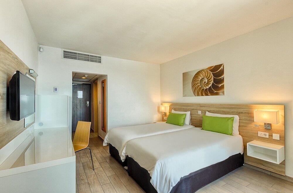 Foto de una habitación de AX ODYCY Hotel