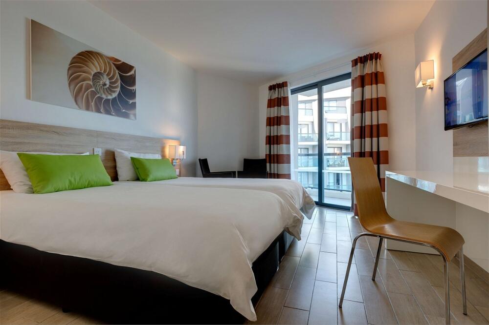 Foto de una habitación de AX ODYCY Hotel