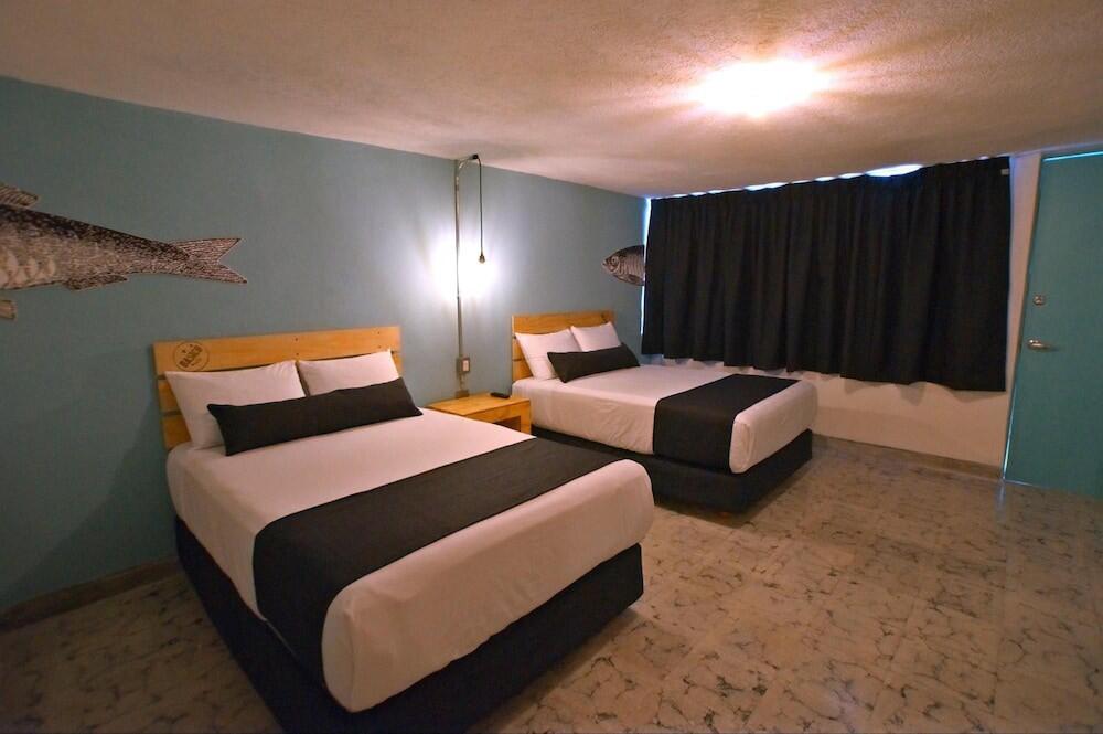 Foto de una habitación de Mas Basico Hotel
